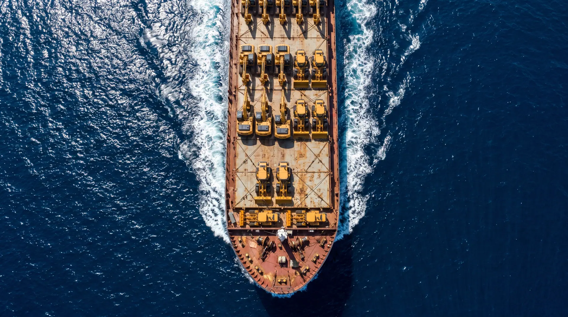 A heavy-lift vessel carrying new machinery, seen from directly above